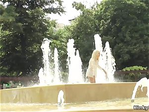 blond made to bathtub in public stream